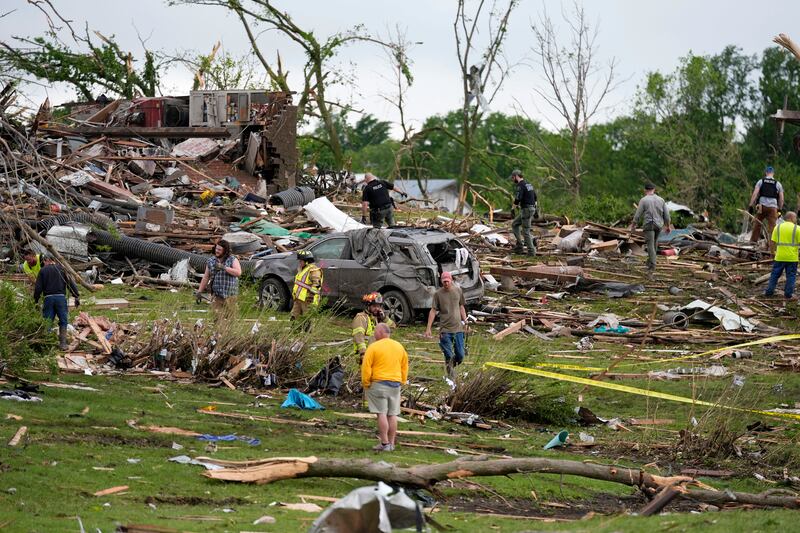 Workers searched the remains of tornado-damaged homes in Greenfield (Charlie Neibergall/AP)