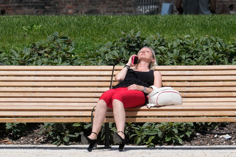 A woman sunbathes in a park in Milan, Italy (Luca Bruno/AP)