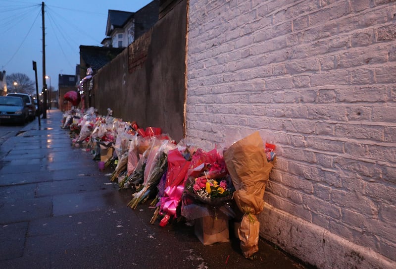 Floral tributes rest against a wall following the murder of Tanesha Melbourne-Blake in Chalgrove Road, Tottenham .