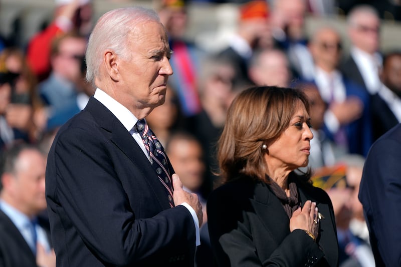 Joe Biden and Kamala Harris placed their hands over their hearts as the national anthem played before the wreath-laying ceremony (Mark Schiefelbein/AP)