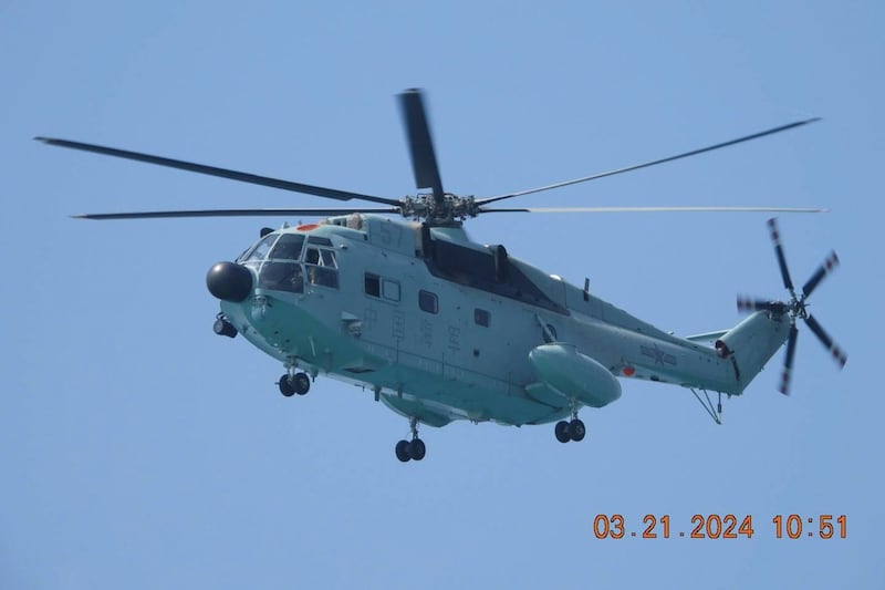 A Chinese military helicopter also took part in the incident (Philippine Coast Guard via AP)