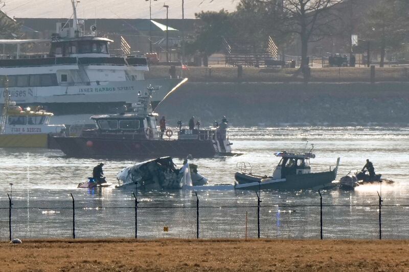 Search and rescue efforts are seen around the wreckage site in the Potomac river near Ronald Reagan Washington National Airport (AP Photo/Mark Schiefelbein)