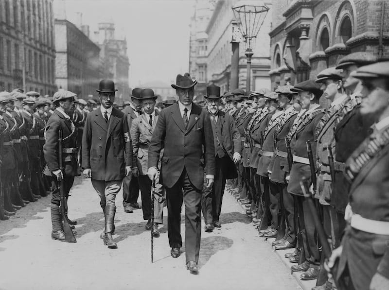 James Craig was the first prime minister of Northern Ireland. Pictured walking by troops