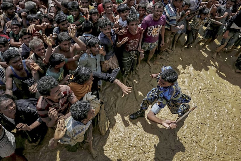 A security officer attempts to control Rohingya refugees waiting to receive aid in Cox&#39;s Bazar, Bangladesh, September 21 2017. Picture by Cathal McNaughton/Reuters 