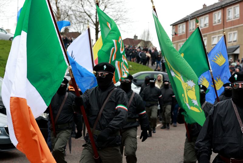 Masked men take part in the dissident parade in Derry