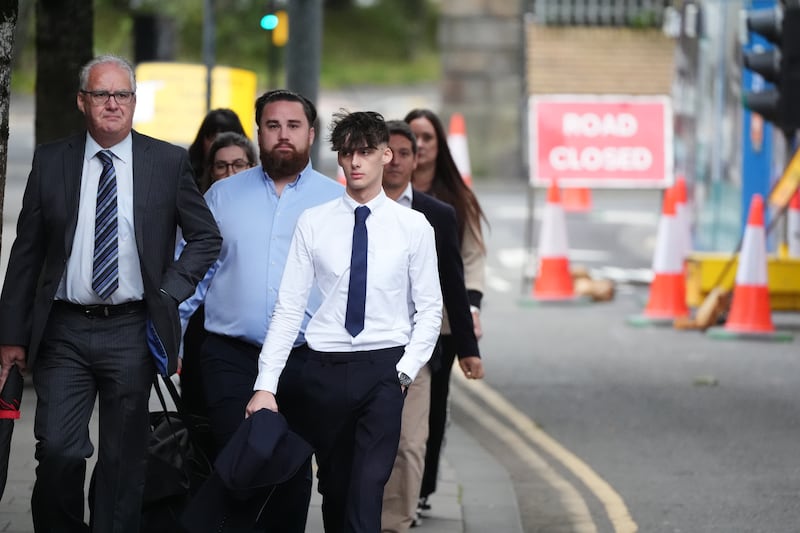 Jake Loy (carrying jacket) was jailed at the High Court in Glasgow for killing three of his friends in a car crash in 2022