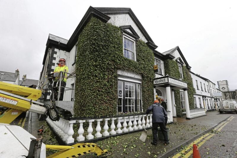 The ivy being cut back on the Londonderry Arms Hotel in Carnlough. Picture by Hugh Russell 