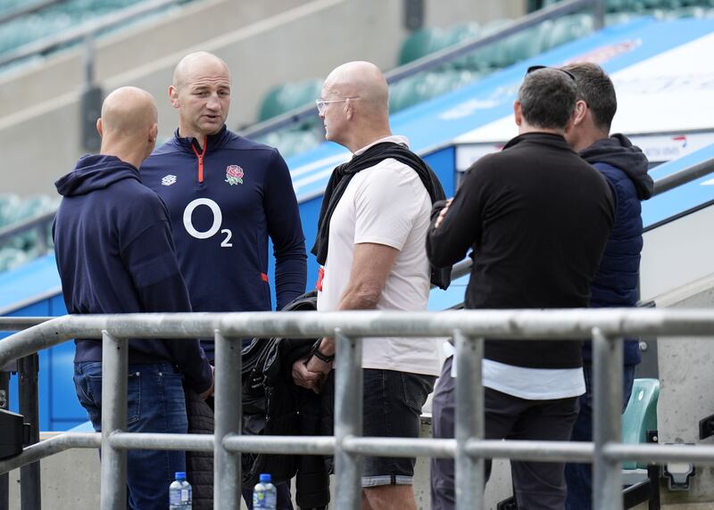 England head coach Steve Borthwick stands with a group of others during a training session at Twickenham