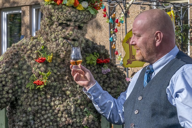 The Burryman shares a whisky with Tony Hamlin as part of the age-old tradition