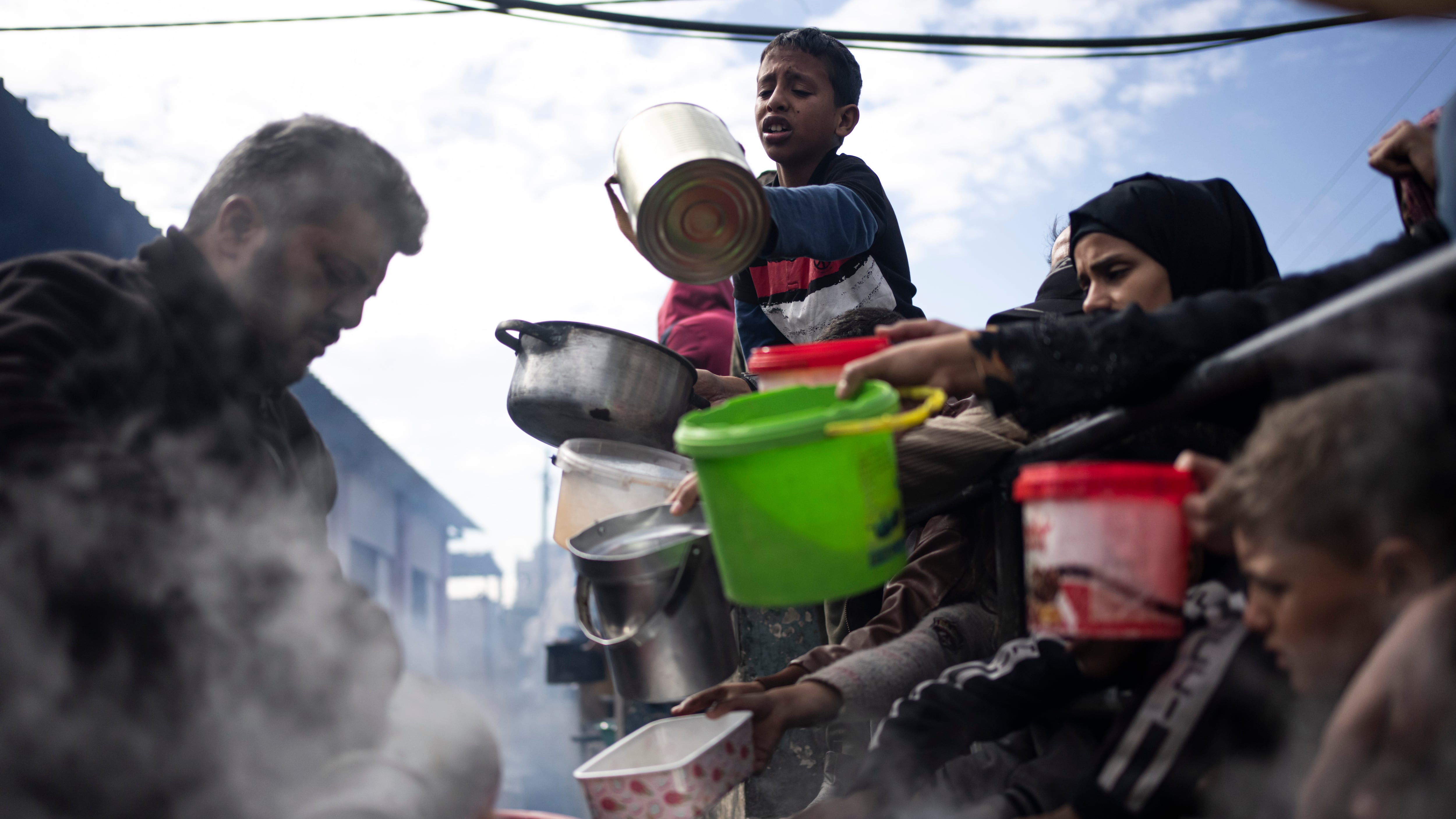 Palestinians line up for food in Rafah (Fatima Shbair/AP)