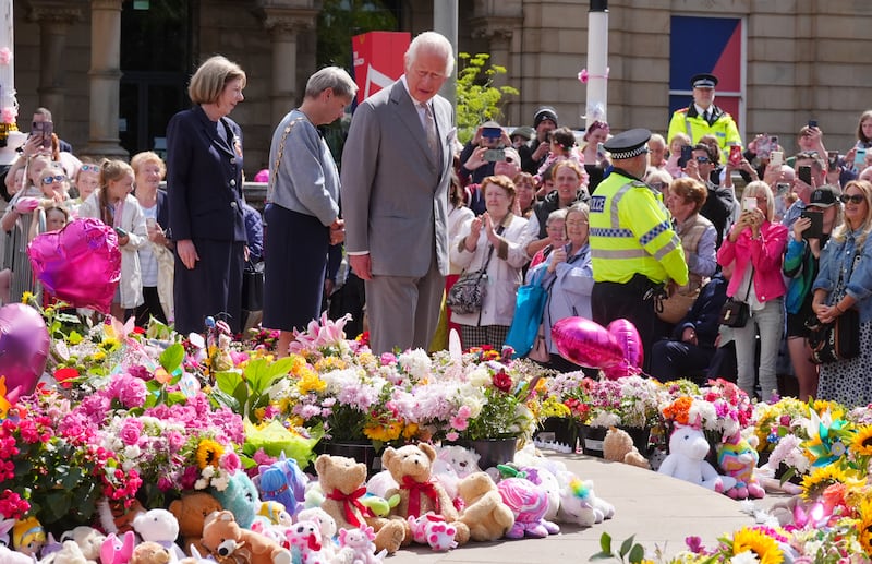 The King views the flowers and tributes outside the Atkinson Art Centre in Southport