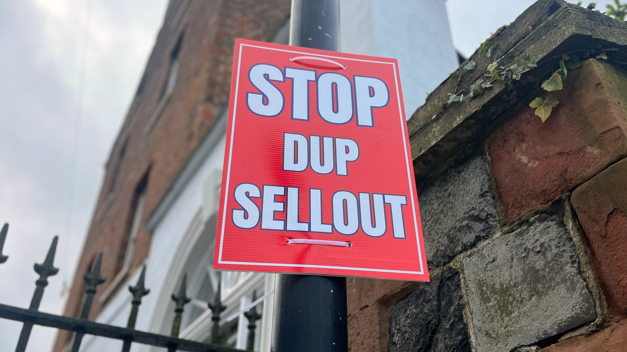 A poster stating ‘Stop DUP sellout’ on a lamp post near Hillsborough Castle, where representatives from the Northern Ireland political parties are meeting for further talks with the Government on a financial package for the region