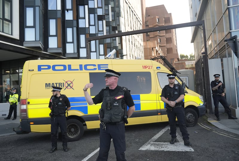 Police officers and a police van block the vehicle entrance at Liverpool Magistrates’ Court