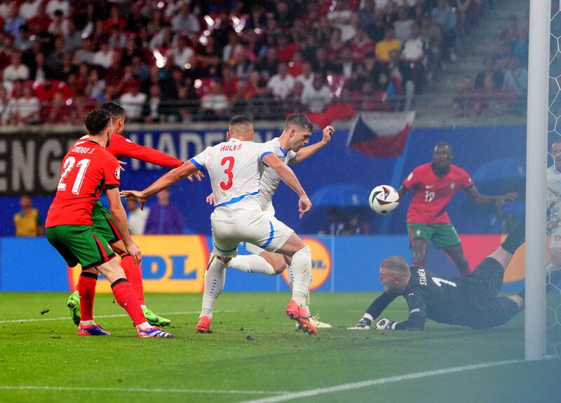 The Czech Republic’s Robin Hranac, centre, scores an own goal to draw Portugal level at 1-1