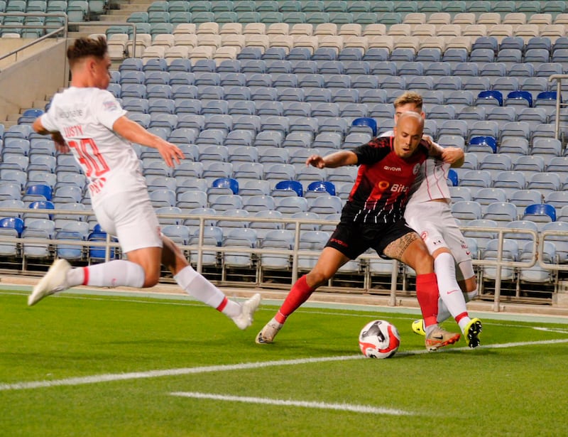 Larne’s Matty Lusty and Dylan Sloan puts the Red Imps full back Santana under pressure. Picture: David McCormick/Pacemaker