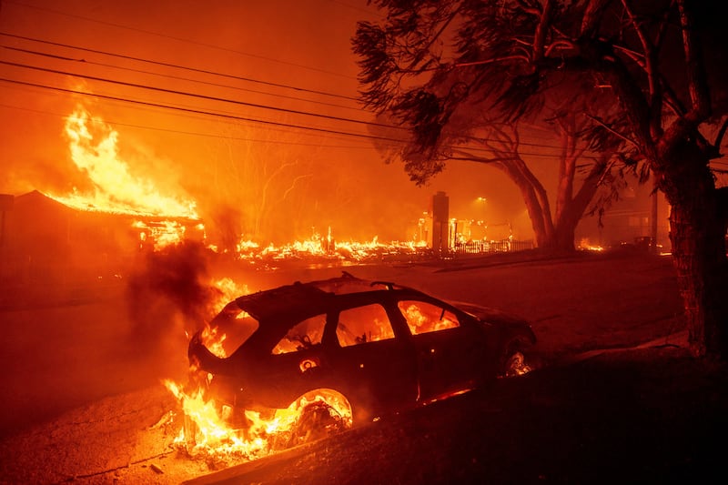 The Palisades Fire burns vehicles and structures in the Pacific Palisades neighbourhood of Los Angeles (Ethan Swope/AP)