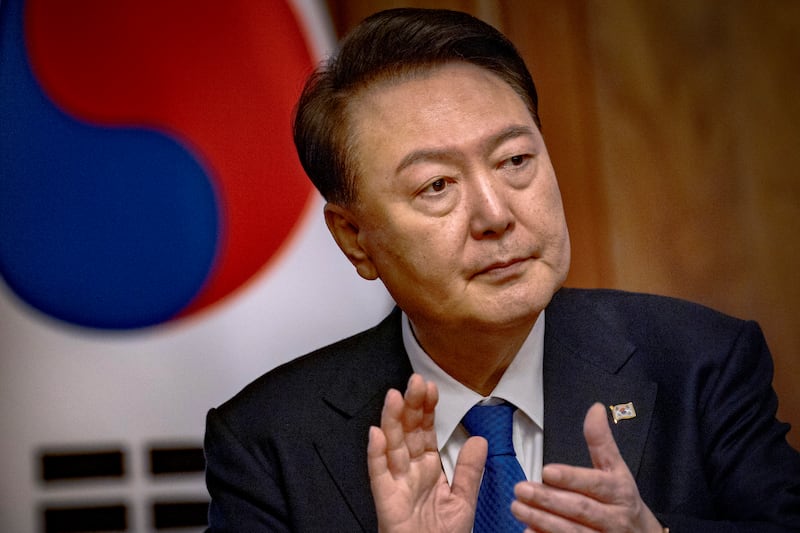 South Korean President Yoon Suk Yeol applauds during a meeting (Ezra Acayan/AP)