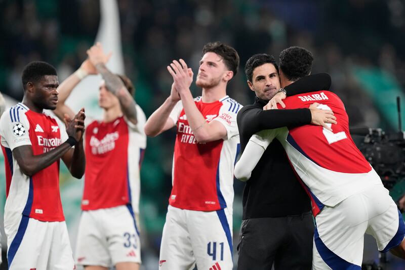 Arsenal’s players celebrate their 5-1 victory over Sporting (Armando Franca/AP)