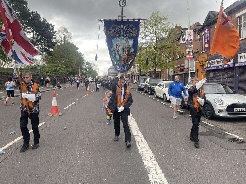 Members of the Orange Order and marathon runners on Ormeau Road on Sunday