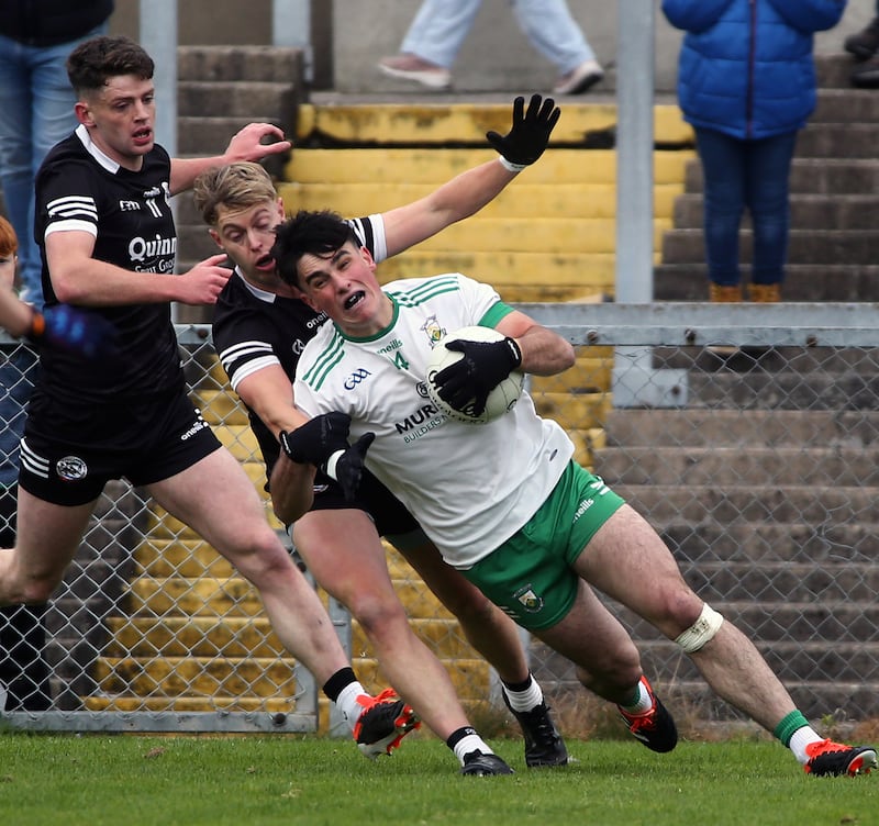 Burren's Niall Toner challenged by Kilcoo's     Jerome Johnston in the Down SFC Final.