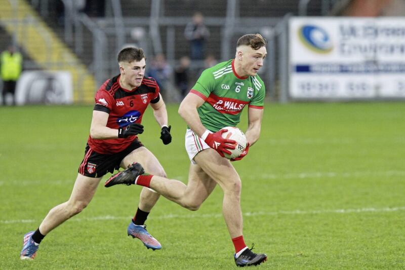 Conor Brady storms forward for Gowna as Killygarrty&#39;s Cian Reilly tracks his run in the Cavan SFC Final. Photo: Adrian Donohoe 