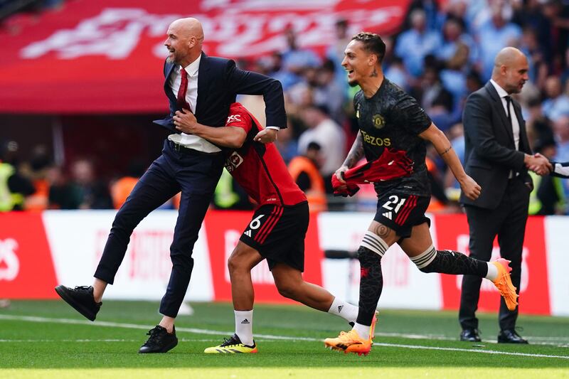 Erik ten Hag (left) celebrates with Lisandro Martinez at the final whistle