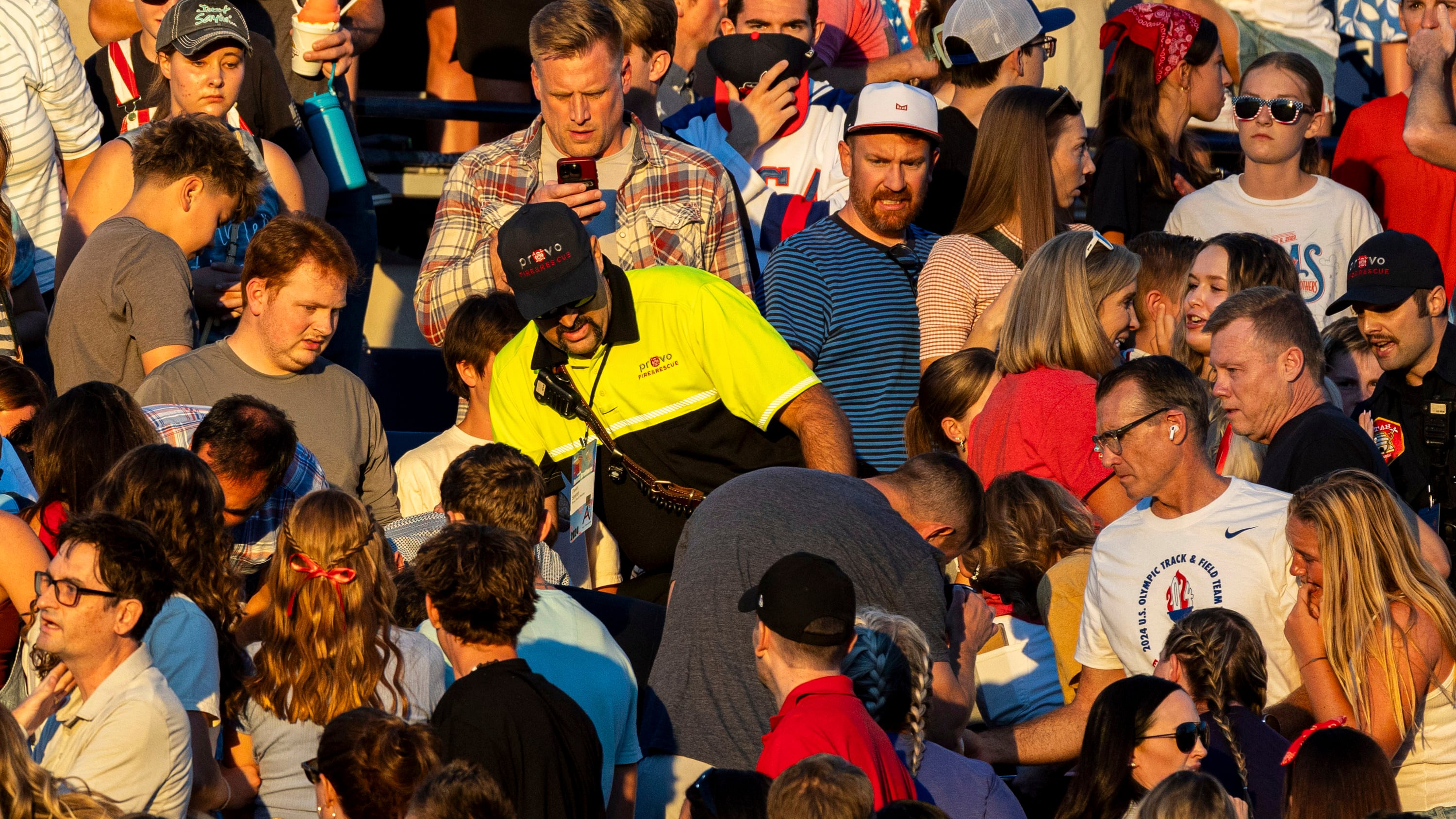 The crowd watches as a firefighter searches for an injured individual after an errant firework exploded among attendees during Stadium of Fire held at LaVell Edwards Stadium in Provo, Utah (Isaac Hale/AP)