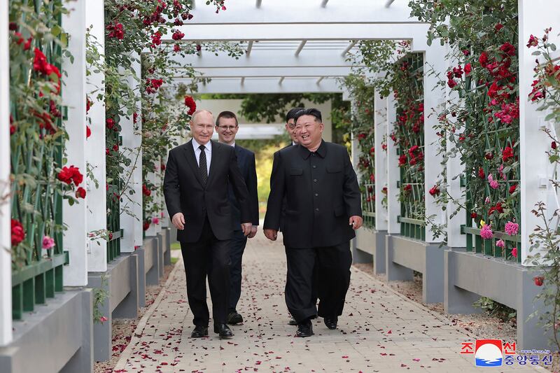 North Korean leader Kim Jong Un, right, and Russia’s President Vladimir Putin, left, walk through a garden of the Kumsusan State Guest House in Pyongyang (Korean Central News Agency/Korea News Service/AP)