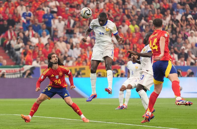 Randal Kolo Muani, centre, powers France into the lead against Spain with an early header