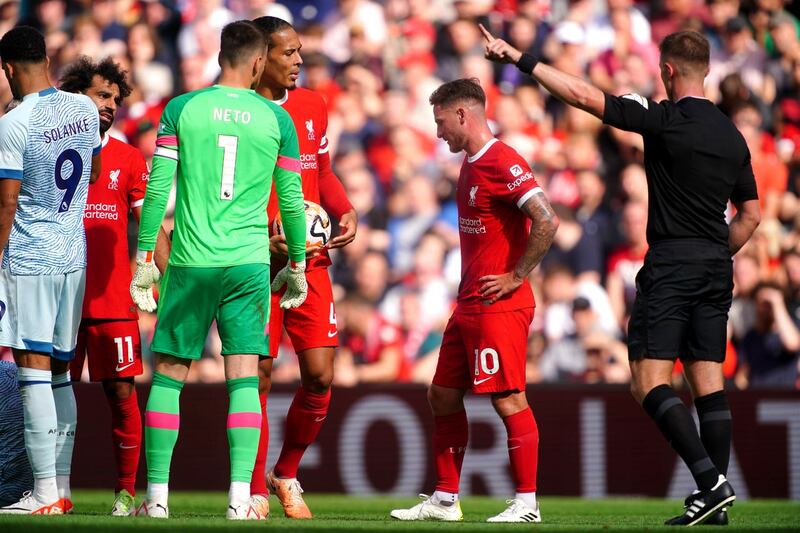 Referee Thomas Bramall (right) shows a red card to Liverpool’s Alexis Mac Allister