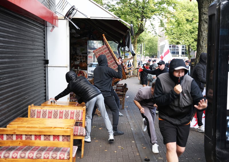 People taking part in an anti-Islamic protest attack a cafe in Botanic Avenue in Belfast