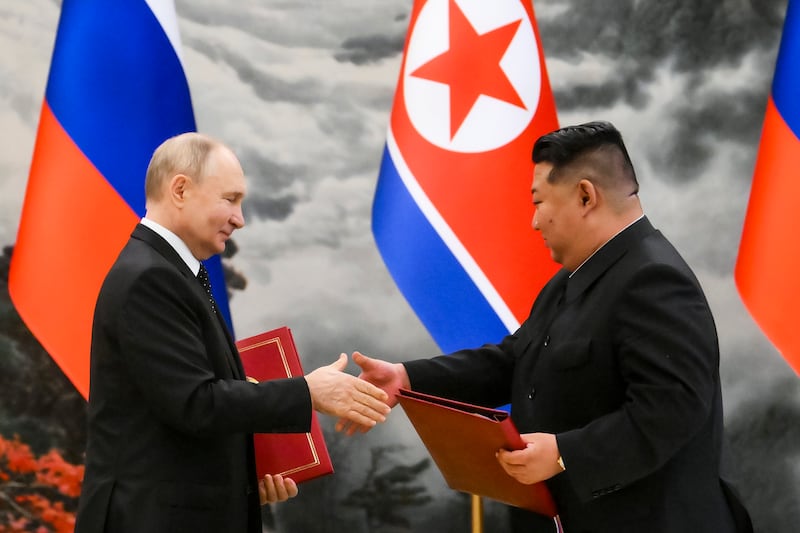 Vladimir Putin and Kim Jong Un exchange documents during a signing ceremony in Pyongyang (Kristina Kormilitsyna, Sputnik, Kremlin Pool Photo via AP)