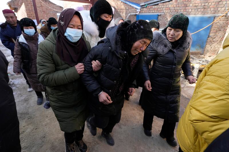 A funeral of a quake victim takes place in Yangwa village near Dahejia town (AP)