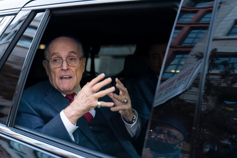Rudy Giuliani talks to reporters as he leaves after his defamation trial in Washington, in December 2023 (Jose Luis Magana/AP)
