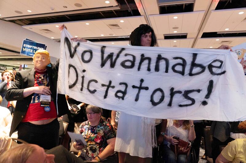 A sign reading ‘No Wannabe Dictators’ is shown at Mr Trump’s speech (AP Photo/Jose Luis Magana)