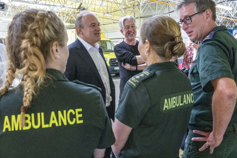 Liberal Democrats leader Sir Ed Davey talks to staff during a visit to Wimbledon Ambulance Station