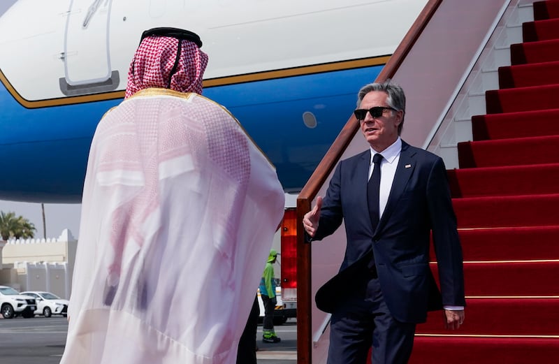 Qatari Ministry of Foreign Affairs Chief of Protocol Ibrahim Fakhroo welcomes US Secretary of State Antony Blinken, right, as he arrives in Doha, Qatar (Nathan Howard/AP)