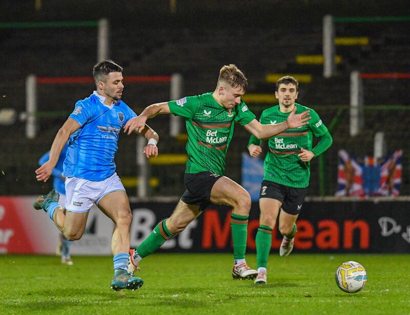 Jonathan Russell of Glentoran tackled by Joe Moore of Ballymena during this Evening’s game at the Bet McLean Oval, Belfast