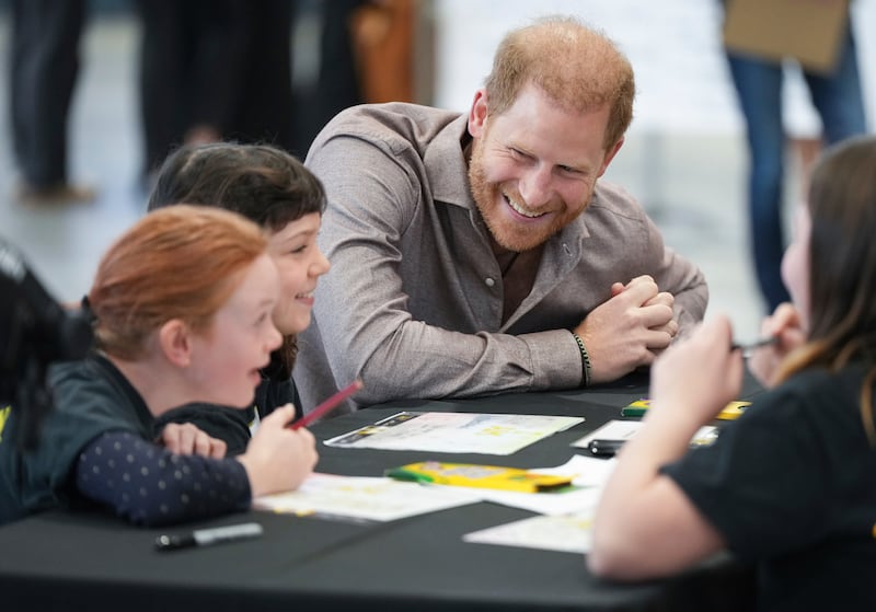 Prince Harry talks with students from Shaughnessy Elementary School during an event to launch the Invictus Games school program (Darryl Dyck/The Canadian Press via AP)