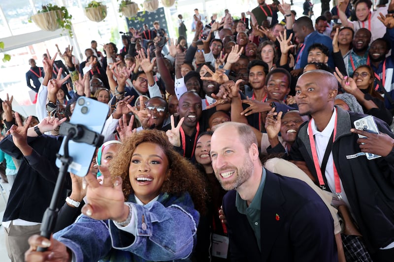 The Prince of Wales and Nomzamo Mbatha (left) pose for a selfie while meeting young environmentalists from across Africa and Southeast Asia