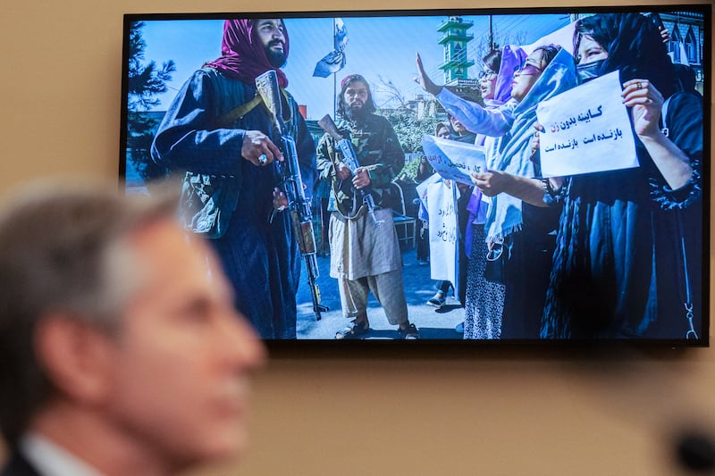 Antony Blinken speaks as a photograph from Afghanistan is seen on a television screen during the hearing (Jacquelyn Martin/AP)