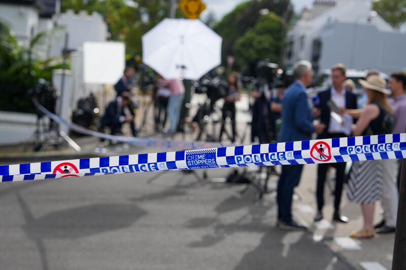 Media wait outside a police cordon at a street where houses were vandalised with anti-Israel slogans (Mark Baker/AP)