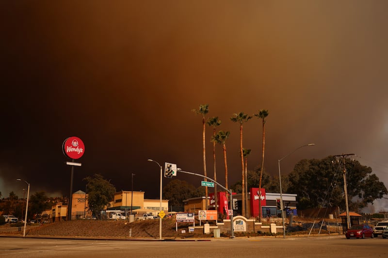 Smoke fills the sky during a wildfire in Castaic, California (Ethan Swope/AP)