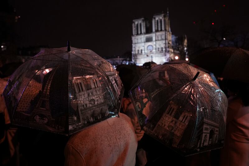 Spectators gather outside Notre Dame Cathedral on Saturday (Alessandra Tarantino/AP)