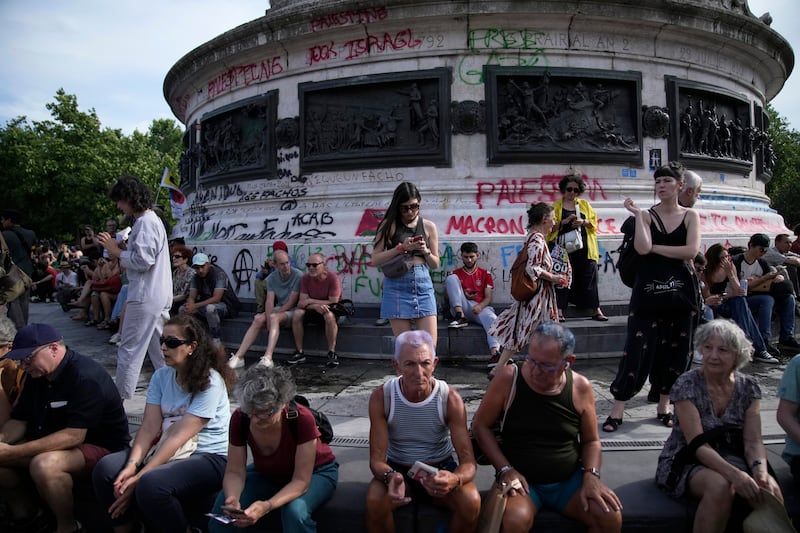 People gather in Paris’s Republique Plaza for a protest over the surging nationalist far right (Christophe Ena/AP)