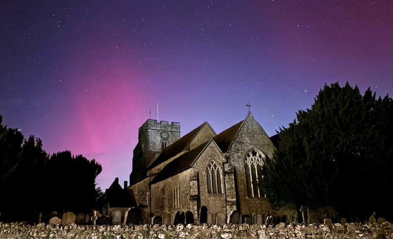 The Northern Lights on display in the skies over Great Chart Church, Ashford, Kent