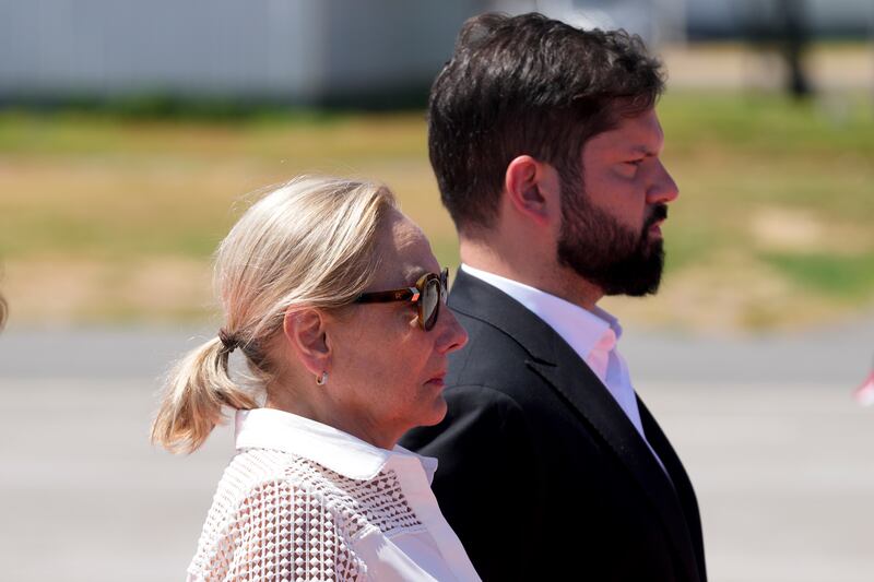Cecilia Morel stands with Chilean President Gabriel Boric to receive Mr Pinera’s coffin (Esteban Felix/AP)