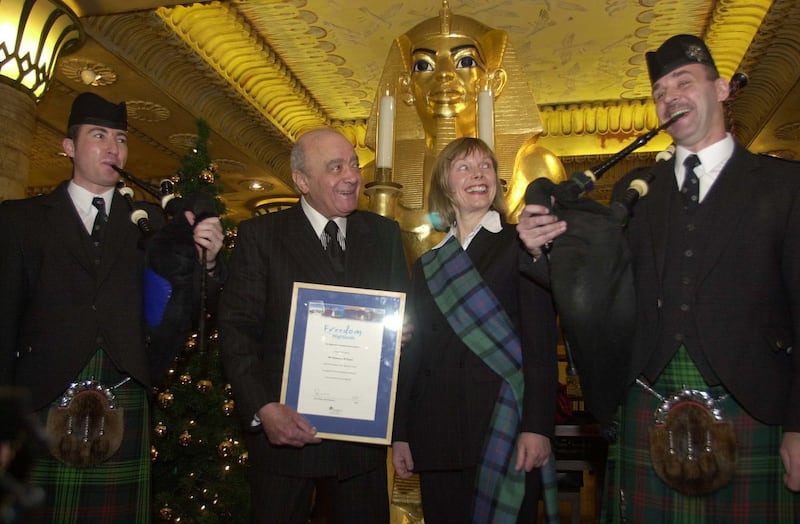 Mohamed Al Fayed accompanied by pipers after accepting a Freedom of the Highlands certificate