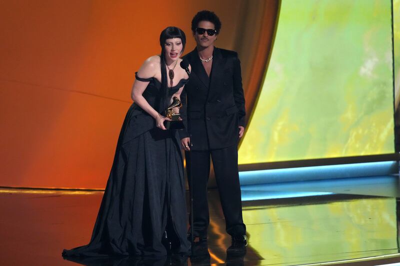 Lady Gaga and Bruno Mars accept the award for best pop duo/group performance for Die With A Smile (Chris Pizzello/AP)