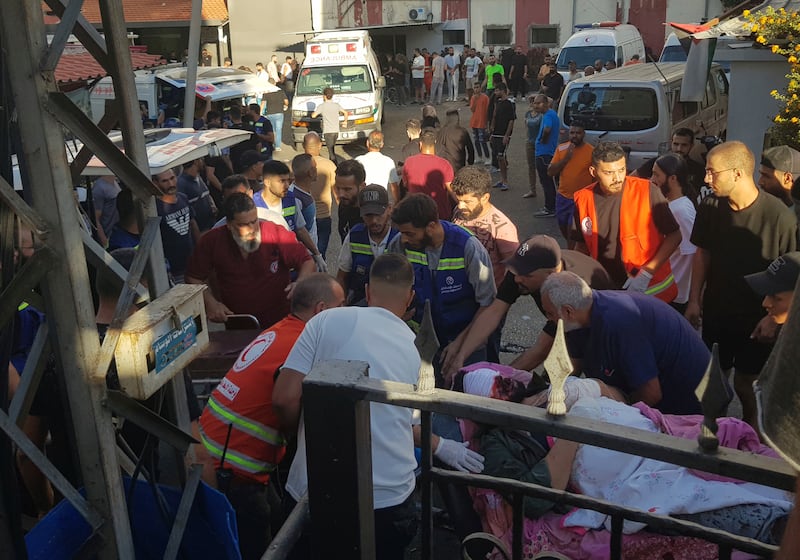 Civil Defence first responders carry a man who was wounded after his handheld pager exploded (STR/AP)